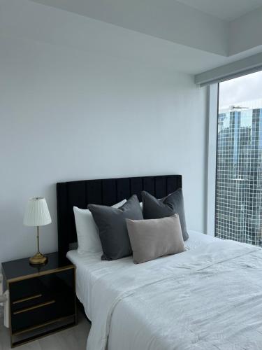 a bedroom with a large bed and a window at Luxury Cityscape Condo in Toronto