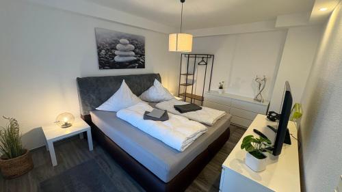 a small bedroom with a bed and a table at Sweet Sleep Apartment in Burg Stargard