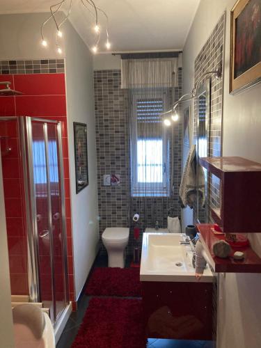 a bathroom with a toilet and a sink and a shower at Vespro 1 Apartment - near the Greek theater in Syracuse