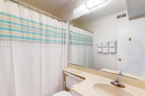 a bathroom with a sink and a toilet and a mirror at ABSW163 Southwinds H13 in Atlantic Beach