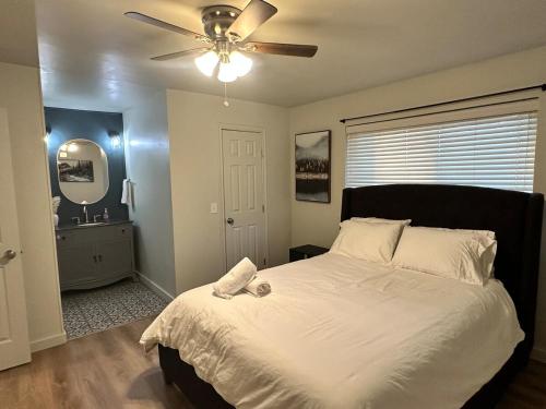 a bedroom with a large bed with a ceiling fan at NEW Modern Retreat in Richardson