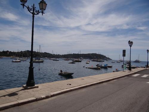 a street light next to a body of water with boats at Les pieds dans la mer Best place in Villefranche-sur-Mer