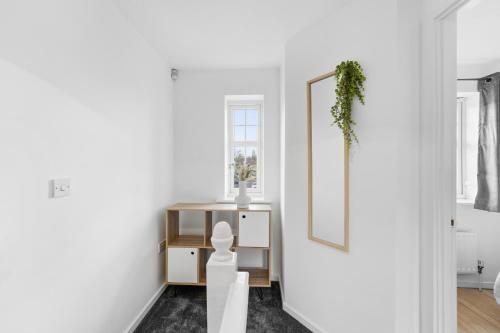 a white room with a table and a mirror at HomeBase Midlands Contractors Relocation Parking in Walsall