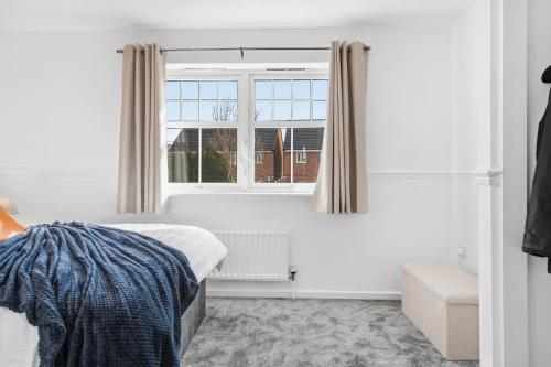 a bedroom with a bed and a window at HomeBase Midlands Contractors Relocation Parking in Walsall
