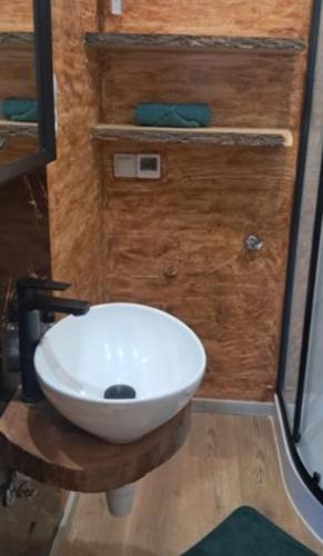 a bathroom with a white sink and a shower at Niesamowita Dolina in Zdonia