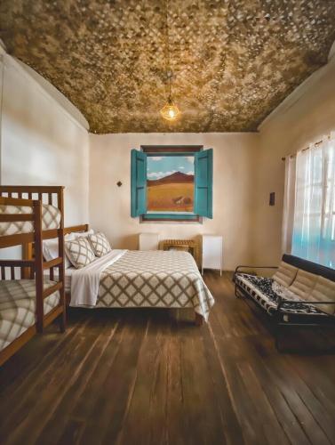 a bedroom with a bed and a painting on the ceiling at Vientos - La Yareta in San Pedro de Atacama