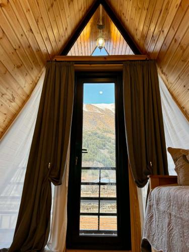 a bedroom with a large window in a tent at Sno loveland in Sno
