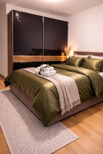 a bedroom with a large bed with a large headboard at Avenoir Suite in Banja Luka