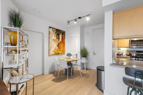 a kitchen and a dining room with a table and chairs at 12 Best Location Cozy Apartment in Los Angeles