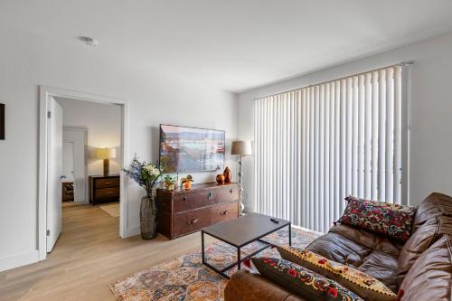 a living room with a couch and a table at 12 Best Location Cozy Apartment in Los Angeles