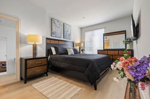a bedroom with a bed and a dresser and a mirror at 12 Best Location Cozy Apartment in Los Angeles
