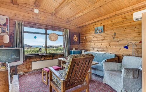 a log cabin living room with a couch and a tv at 2 Bedroom Lovely Home In Faaborg in Faaborg
