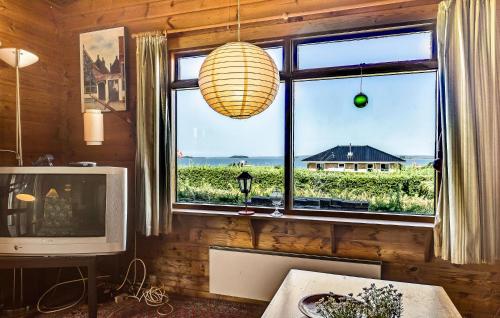 a living room with a large window and a television at 2 Bedroom Lovely Home In Faaborg in Faaborg