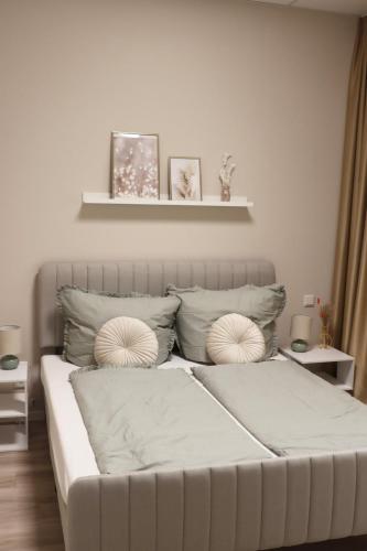 a white bed with two pillows on top of it at City-Apartment Braunschweig in Braunschweig