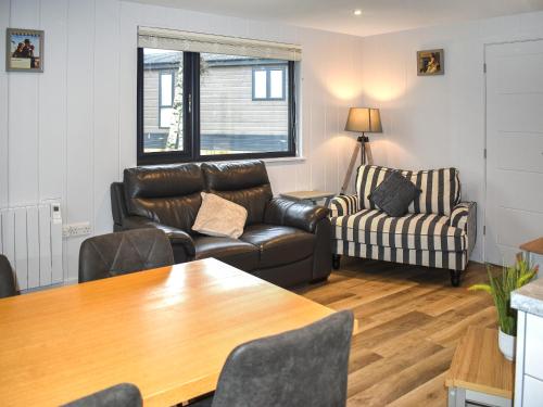 a living room with a couch and a table at Lodge 6- Uk51084 in Lyme Regis