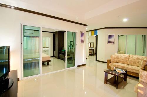 a large living room with a couch and a bed at Makathanee Resort in Ko Mak