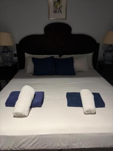 a large bed with two pillows on top of it at Charming poolside condo in Cap Cove in Cap Estate