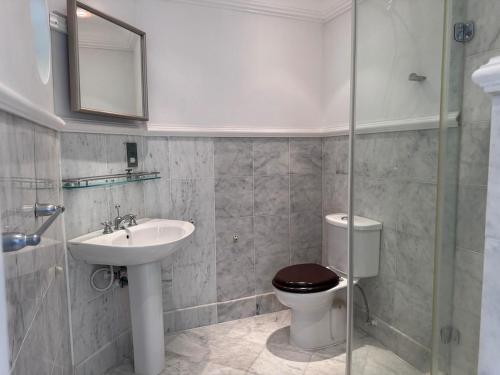 a bathroom with a toilet and a sink at Charming poolside condo in Cap Cove in Cap Estate