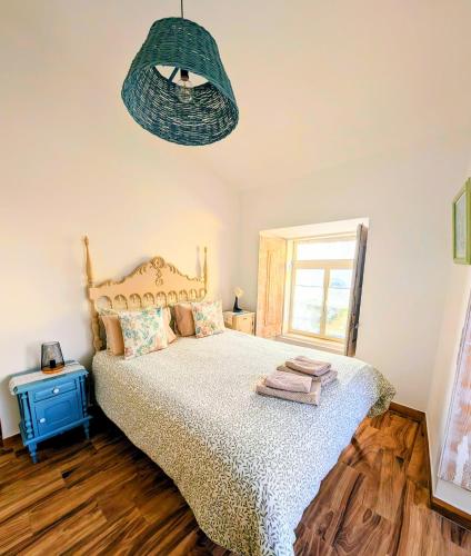 a bedroom with a bed and a pendant light at Vida à portuguesa, Charming apartment "Algarve" , in the cultural and historical center in Portimão