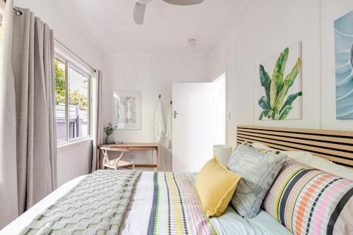 a bedroom with a large bed and a window at Kaimana in Gold Coast