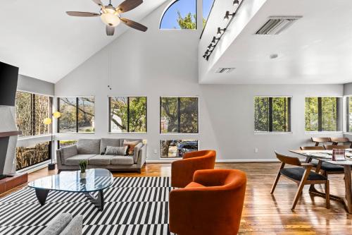 a living room with a vaulted ceiling with windows at Beautiful home by Medical ctr, Rice, Museums in Houston