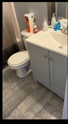 a bathroom with a white toilet and a sink at The Relaxing Home in Memphis