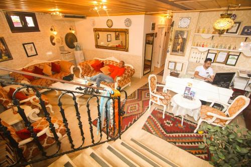 a man sitting at a table in a living room at Esans Hotel - Special Category in Istanbul