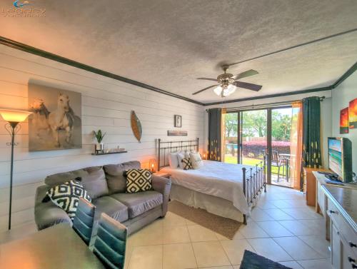 a living room with a bed and a couch at Pirates Bay B114 in Fort Walton Beach