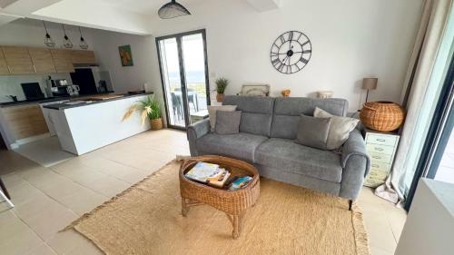 a living room with a couch and a table at VILLA MAGIC - Ocean Views with Pool, Starlink WiFi, Cistern & Generator in Oyster Pond