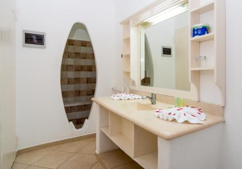 a bathroom with a sink and a mirror at Albachiara Hotel - Las Terrenas in Las Terrenas