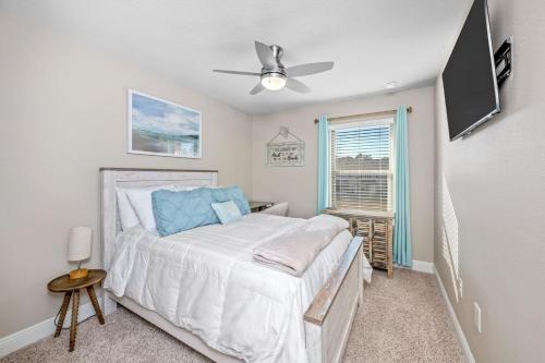 a bedroom with a bed and a ceiling fan at SEA-Bound STR in Pensacola