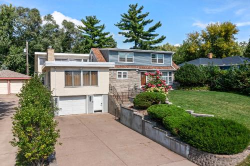 a house with a driveway and a yard at Burban Bungalow in Maplewood