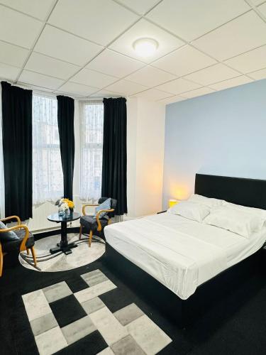 ein Schlafzimmer mit einem Bett, einem Tisch und Stühlen in der Unterkunft Hotel Vibes in Blackpool