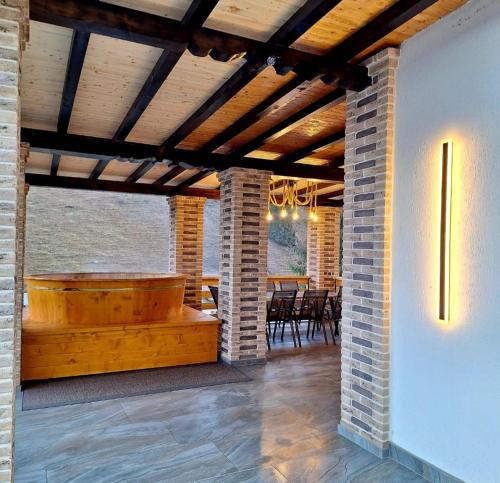 a patio with a wooden tub in a house at Cabana Edav in Ţibău