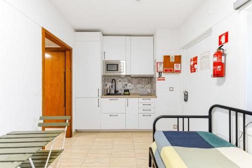 a room with two bunk beds and a kitchen at Resort Apartment Cabanas de Tavira in Tavira
