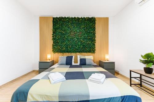 a bedroom with a bed and a green wall at Resort Apartment Cabanas de Tavira in Tavira