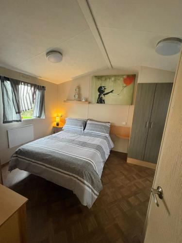 a bedroom with a large bed in a room at Miranda and Pauls Caravan in Leysdown-on-Sea