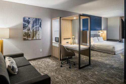 a hotel room with a couch and a bed at SpringHill Suites by Marriott Canfield in Canfield