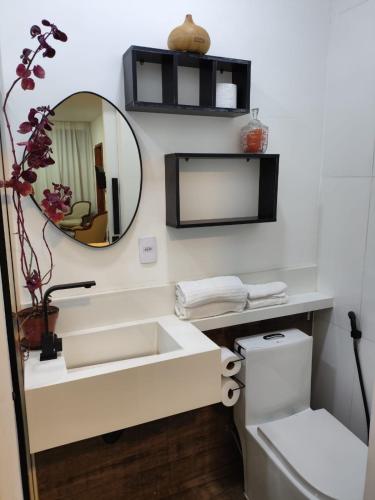 a bathroom with a sink and a mirror at Loft 101 in Rio de Janeiro
