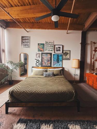a bedroom with a large bed with posters on the wall at 420 Friendly BOHO Loft Downtown KING suite FREE parking in Detroit