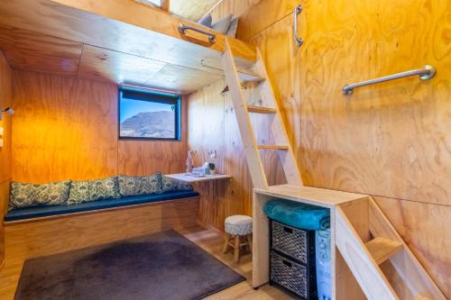 a tiny house with a ladder and a sink at Ora Retreat in Queenstown