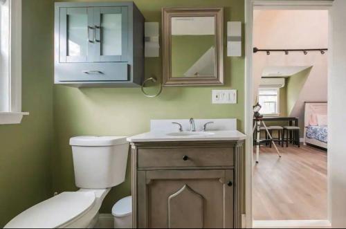a bathroom with a toilet and a sink and a mirror at LARGE STUDIO open concept in Boston Zoo Franklin Park near in Boston