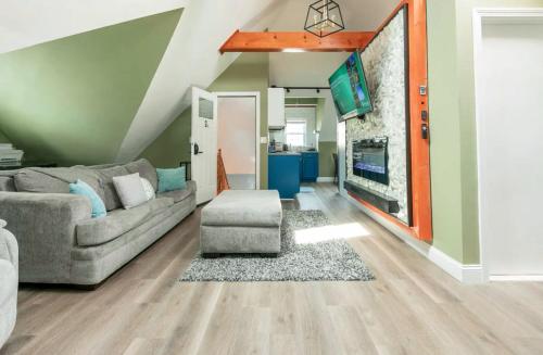 a living room with a couch and a tv at LARGE STUDIO open concept in Boston Zoo Franklin Park near in Boston