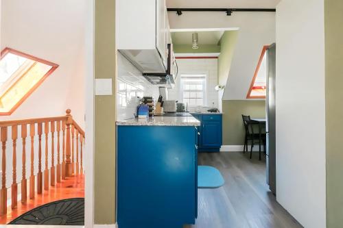 a kitchen with a blue island in a room at LARGE STUDIO open concept in Boston Zoo Franklin Park near in Boston