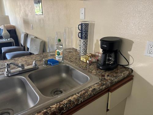 a kitchen counter with a sink and a coffee maker at 1Bd Prime Westwood Location One Block from UCLA in Los Angeles