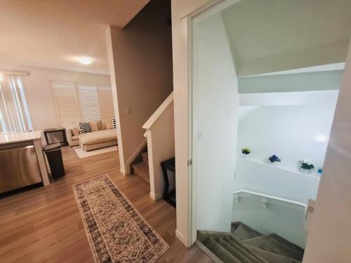 a room with a staircase and a living room at Modern 4BDRM Home-2 King Bed- Full House in Edmonton
