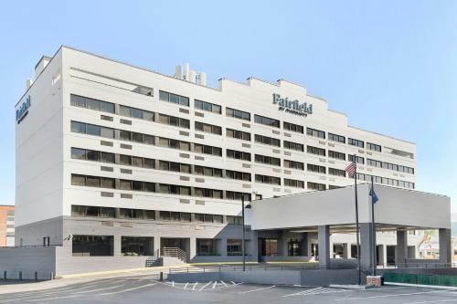 a large white building with a flag in front of it at Fairfield by Marriott Inn & Suites Charleston Downtown in Charleston