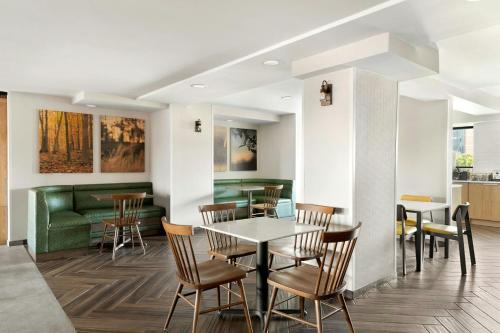 a dining room with a table and chairs and a couch at Fairfield by Marriott Inn & Suites Charleston Downtown in Charleston