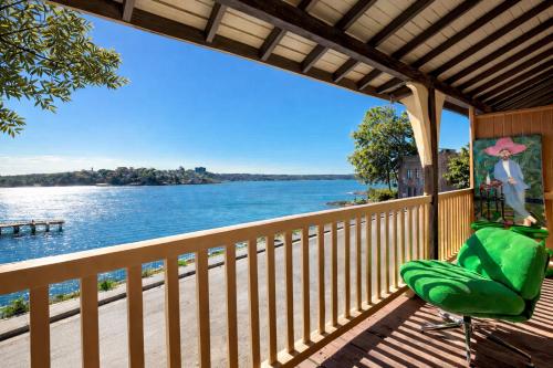 a balcony with a view of the water at Ocean-View Art Stay & Private Rooftop, Walk to Circular Quay in Sydney