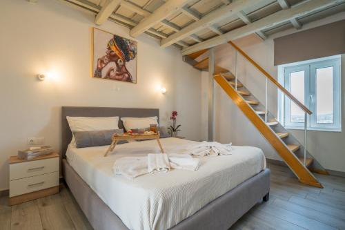 a bedroom with a bed and a staircase at Vista Magica in Chania